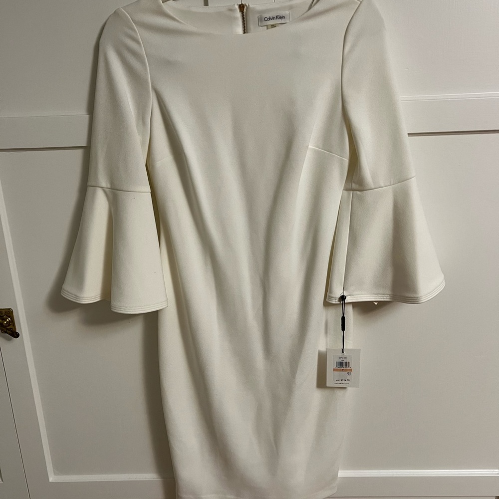 White bell sleeve Calvin Klein dress.